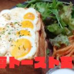 卵とチーズが乗った分厚いトーストのプレート。「厚切りトースト実食！」と書かれた赤い文字が重ねられている。