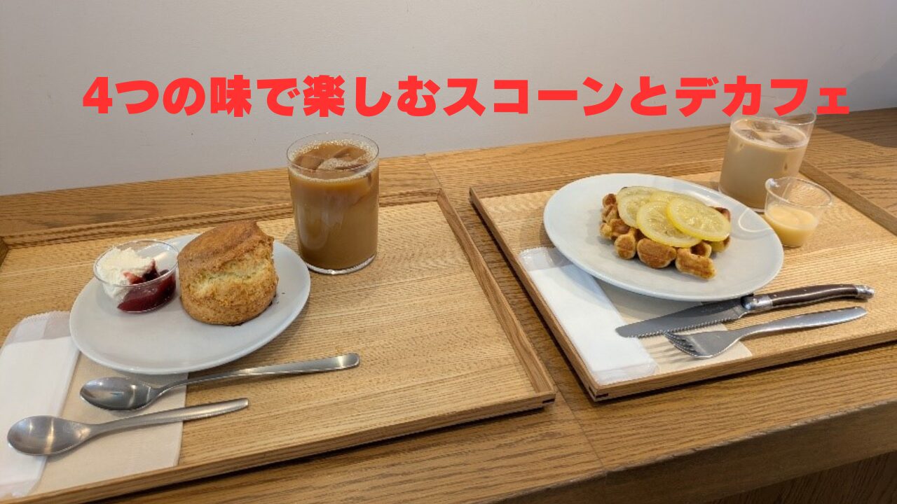 木製トレイに並んだスコーンとジャム、クリーム、アイスコーヒー、レモンワッフルとデカフェラテのカフェセット